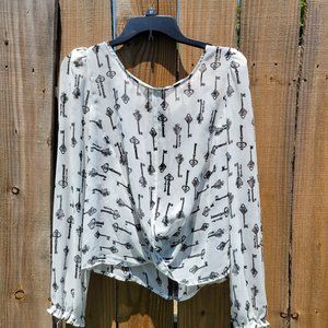 White blouse with black key print.